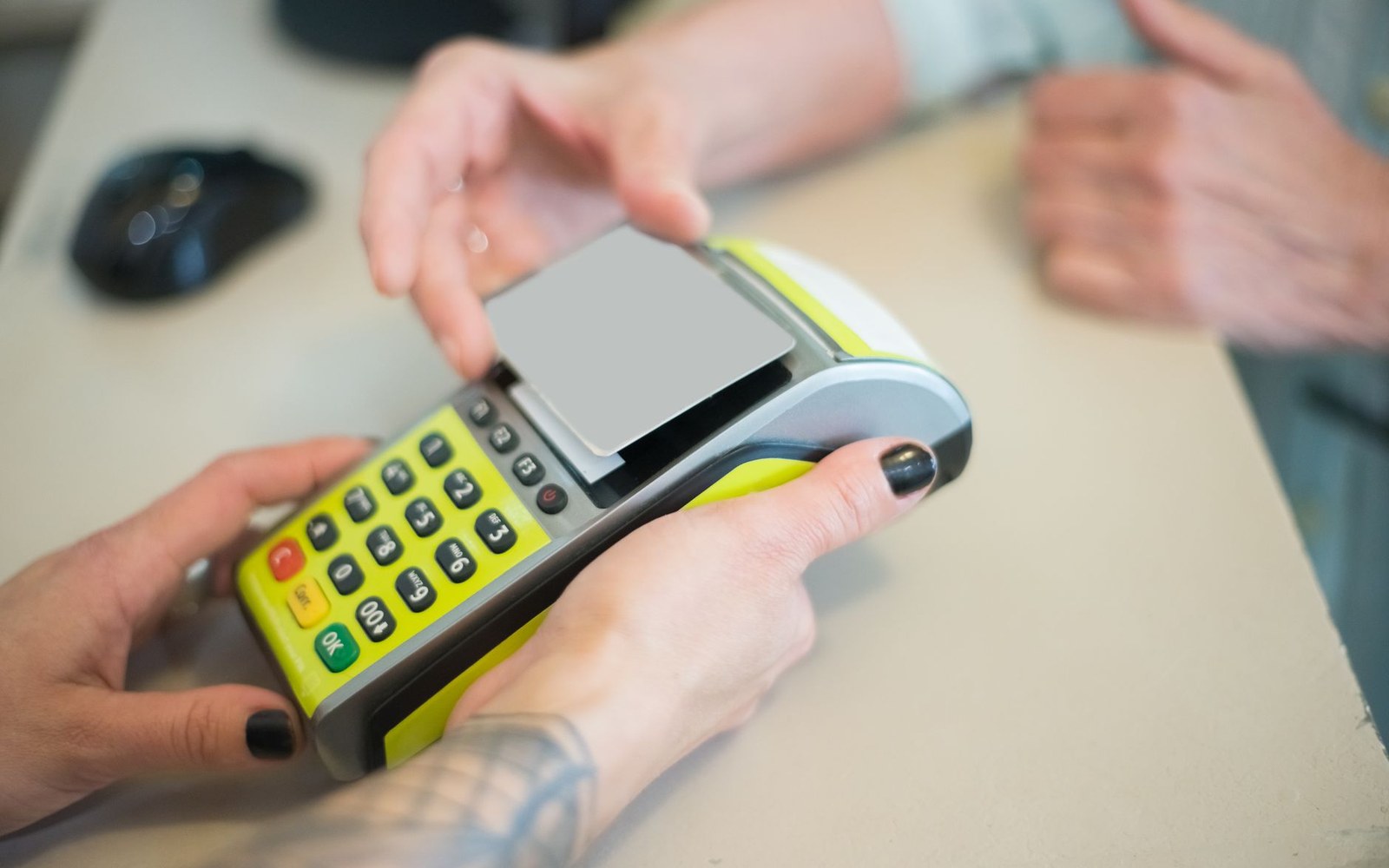 A loyalty card being scanned at a checkout